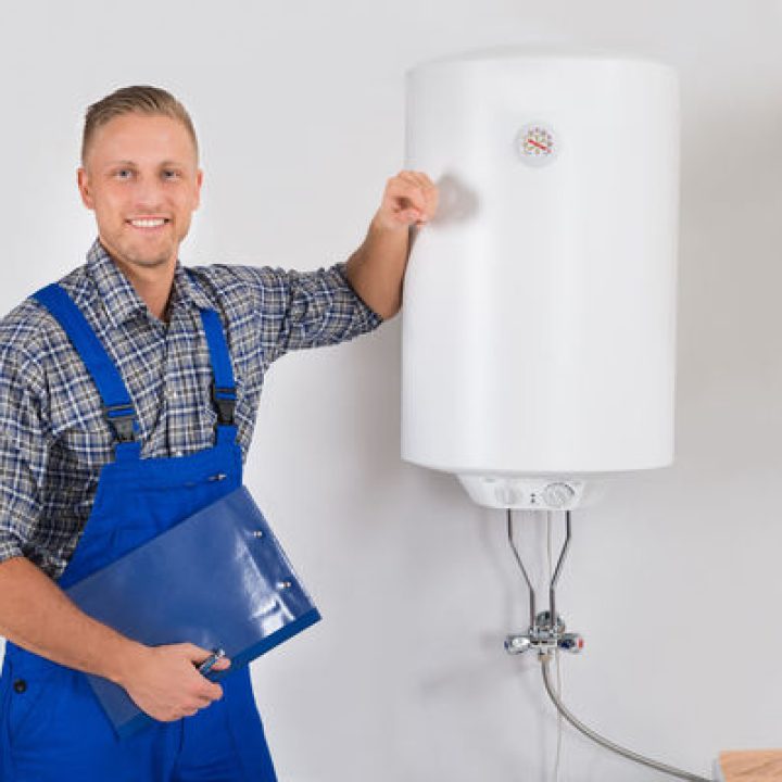 43693864 - young happy plumber in overall holding clipboard and pen